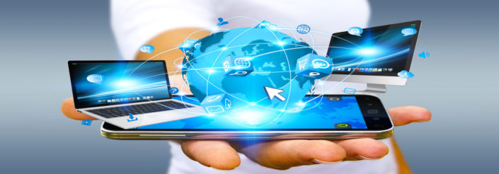 Businessman holding multimedia tech devices in his hand